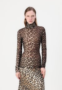 Haut à col roulé ajusté à manches longues en tissu transparent avec un motif léopard, présentant des nuances de marron et de noir pour un contraste visuel.