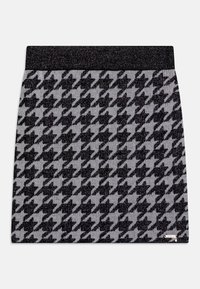 Knit mini skirt with a houndstooth pattern in black and gray, featuring a black, textured waistband and a small logo tag on the hem.