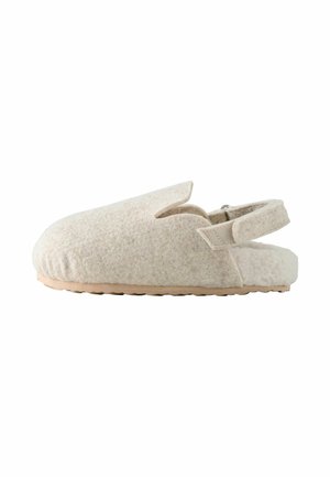 Beige felt slipper with an open back, rounded toe, and a unique cut-out design on the upper. Features a textured sole for grip.