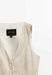 Beige Kord-Baumwoll-Weste ohne Ärmel mit V-Ausschnitt und zwei Knöpfen, mit einem Massimo Dutti Etikett innen am Ausschnitt.
