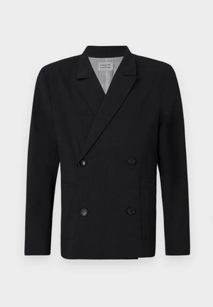 Blazer noir à double boutonnage en tissu lisse, avec deux poches avant et des boutons noirs. Col cranté et silhouette structurée.