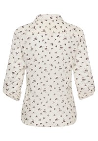 Blouse crème à motifs floraux, manches retroussables, col, en tissu doux et léger. Vue arrière montrant de petites fleurs détaillées.