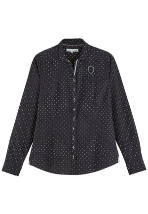 Chemise noire à boutons avec des pois blancs, à manches longues, un col et une poche poitrine. Le tissu semble lisse avec un léger éclat.