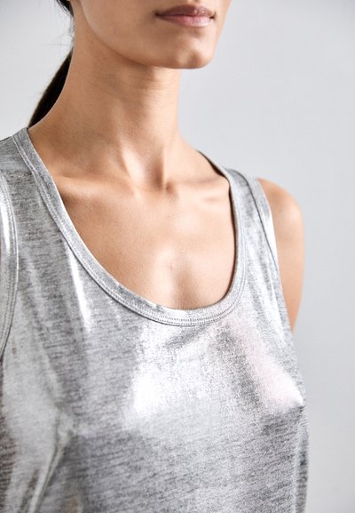Silberfarbener metallischer Tanktop mit rundem Ausschnitt und breiten Trägern, das eine glatte, glänzende Textur aufweist. Nahaufnahme der Stoffdetails.