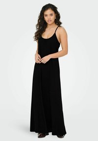 Robe maxi noire avec des bretelles spaghetti fines, une coupe décontractée et une texture lisse. Remarquable par sa simplicité et sa silhouette longue et fluide.