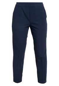 Pantalon bleu marine à texture lisse, coupe fuselée, poches avant et délicat pli le long de l'avant.