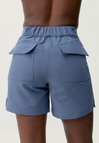 Blue cargo shorts with a stretchy waistband, featuring two large back pockets and a smooth, matte finish.
