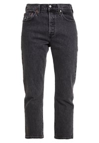 Czarnie dżinsy o wysokim stanie z prostą nogawką, z pięcioma kieszeniami, miedzianymi akcentami i lekko zniszczonym wykończeniem.