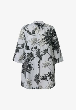 Camicia bianca a maniche lunghe con grande stampa floreale nera e grigia, colletto appuntito e chiusura frontale con bottoni nascosti.