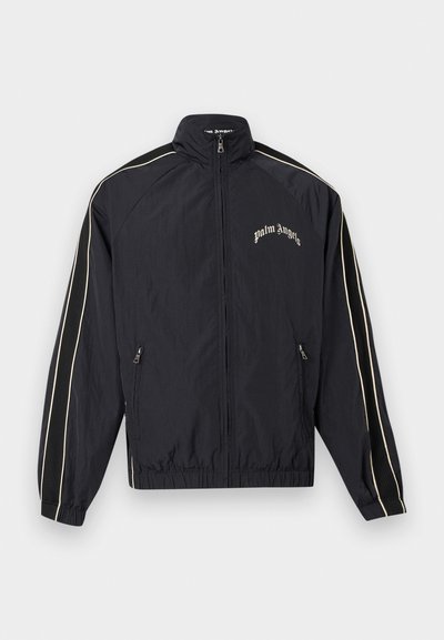 Must zipiga spordijakk, mille varrukatel on valged triibud, elastsed mansetid ja ääred, ees taskud ning rinnal kiri "palm angels".