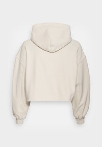 Felpa corta con cappuccio in crema chiaro, caratterizzata da cappuccio, maniche oversized, polsini a coste e tessuto morbido e strutturato.