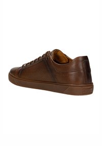 Braune Leder-Sneaker mit perforierten Einsätzen, Gummisohle und runder Zehenpartie. Verfügt über eine Schnürverschluss und dezente Markenkennzeichnung an der Ferse.