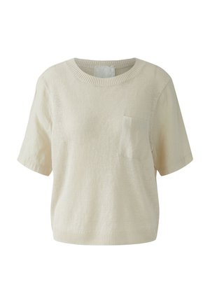 Cremefarbenes kurzärmliges Strickoberteil mit Rundhalsausschnitt und einer kleinen quadratischen Brusttasche auf der linken Seite.