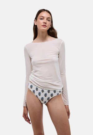 Haut à manches longues de couleur beige clair, associé à un slip blanc orné d'un motif floral bleu et d'une bordure délicate. Texture lisse et coupe ajustée.