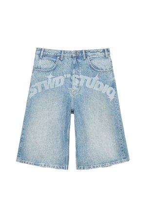 Light blue denim shorts with a slightly faded finish and curved white printed text across the front reading "STWD STUDIO."