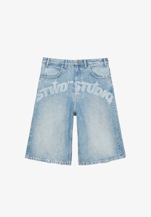 Light blue denim shorts with a slightly faded finish and curved white printed text across the front reading "STWD STUDIO."