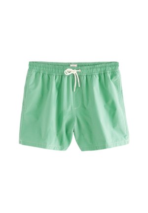 Short de bain vert en tissu léger. Présente une taille élastique avec un cordon de serrage, des poches latérales et des coutures contrastées.