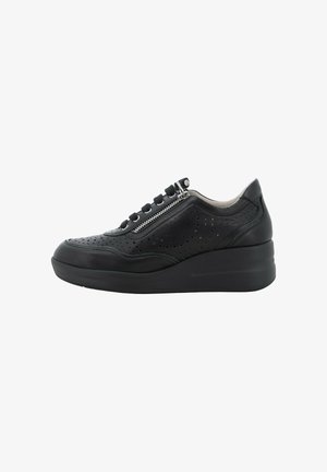 Sneaker con zeppa nera in pelle traforata, cerniera laterale e chiusura con lacci su sfondo bianco.