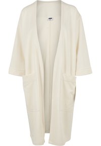 Beige kimono cardigan featuring a loose fit, short sleeves, open front, and two large front pockets. Soft fabric with no additional patterns.