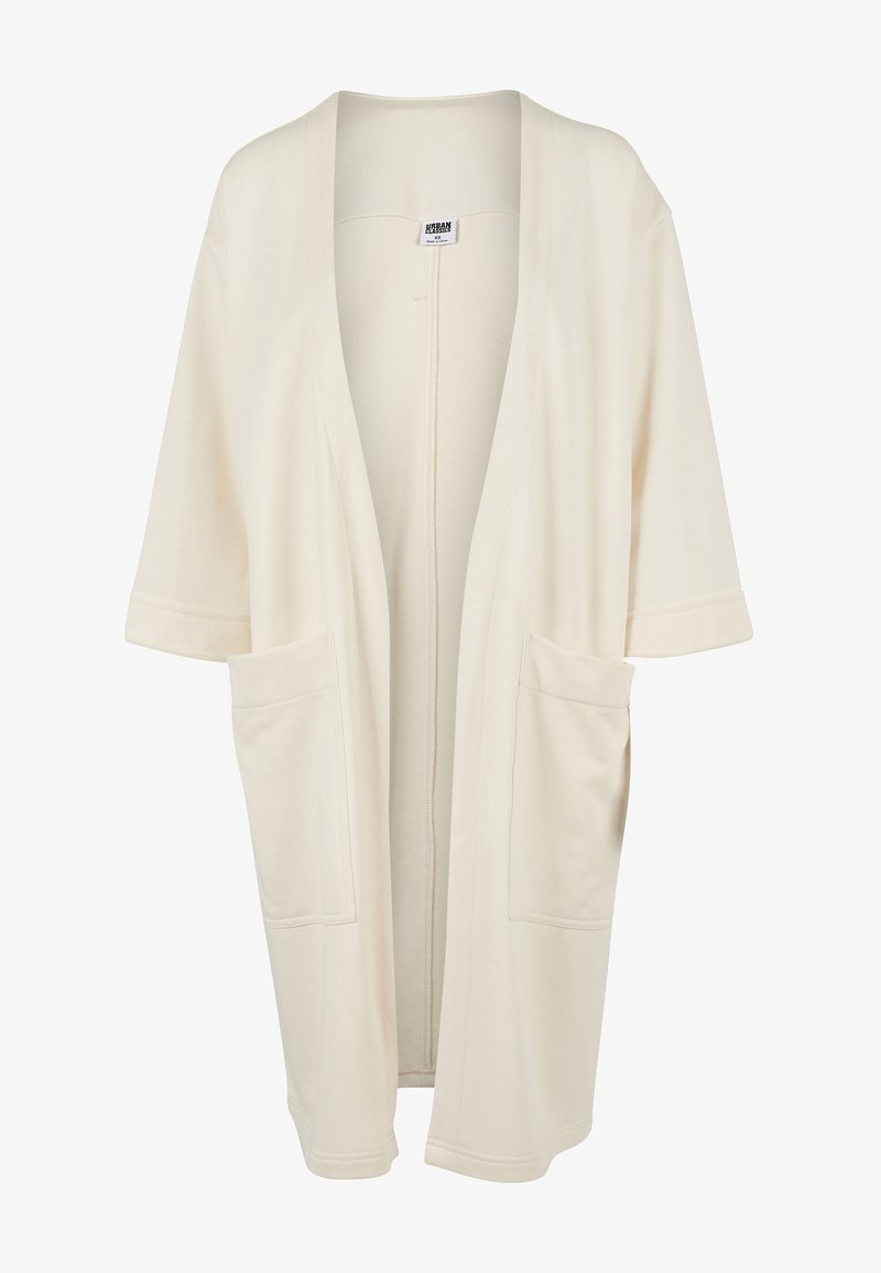 Beige kimono cardigan featuring a loose fit, short sleeves, open front, and two large front pockets. Soft fabric with no additional patterns.