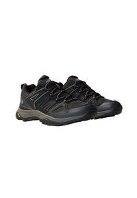 Black athletic shoes with a textured synthetic upper, reflective accents, and a rugged rubber sole for grip and durability.