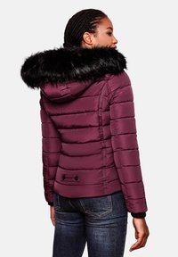 Maroon puffer jacket with a black faux fur hood. Features quilted design, side pockets, and elastic cuffs for a snug fit.