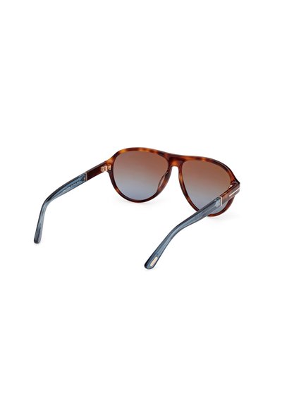 Occhiali da sole tortoiseshell marroni con lenti sfumate e stanghette blu-grigie. Presentano una forma elegante e arrotondata con accentuazioni hardware minime.