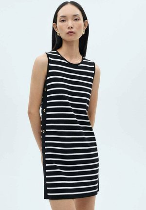 Black and white striped sleeveless dress with a round neckline and gold button accents along the side, made from a smooth fabric.
