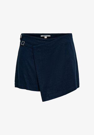 Jupe portefeuille bleu marine foncé avec un ourlet asymétrique et une petite boucle en métal sur la ceinture.