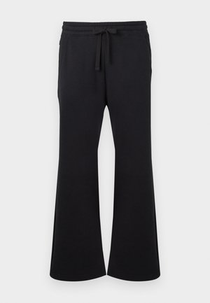 Pantaloni ampi neri con vita regolabile e tasche laterali, realizzati in tessuto morbido.