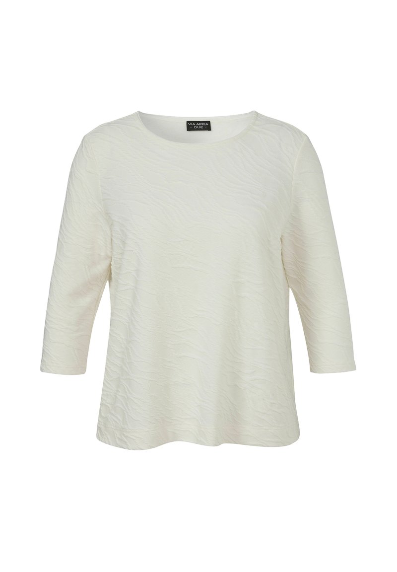 Blouse blanche texturée à manches longues avec un col rond et un ourlet légèrement évasé, présentée sur un fond blanc uni.