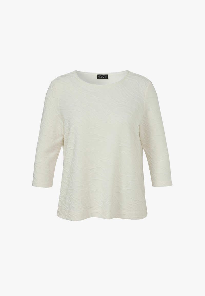 Blouse blanche texturée à manches longues avec un col rond et un ourlet légèrement évasé, présentée sur un fond blanc uni.