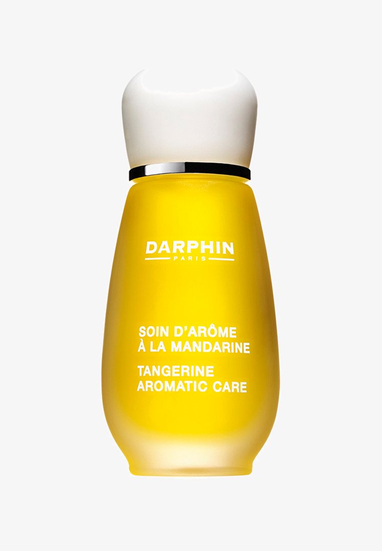 Keltainen lasipullo, jossa on valkoinen pyöreä korkki. Pullossa on rohkeaa valkoista tekstiä, joka lukee "DARPHIN," "SOIN D'ARÔME À LA MANDARINE," ja "TANGERINE AROMATIC CARE."