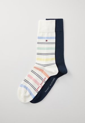 Calzini a righe bianchi e blu marina, con righe multicolori in rosso, verde, giallo e blu, dotati di dettaglio con logo alla caviglia.