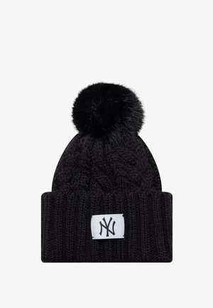 Black knitted winter beanie with large pom-pom on top and white patch featuring black intertwined "NY" logo on cuff.