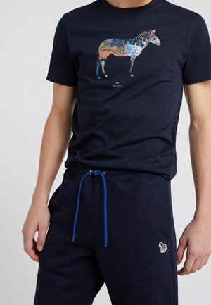 Navy blue cotton t-shirt featuring a colorful zebra graphic design at the front. Paired with navy sweatpants with a blue drawstring.