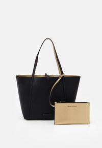 Czarna torba na ramię z długimi uchwytami i beżową odpinaną kieszonką z logo Armani Exchange, na białym tle.