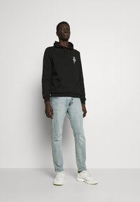 YOURTURN by Zalando - UNISEX - Hoodie - black Thumbnail Image 1
