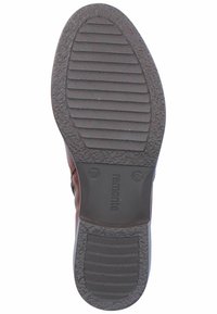 Braune synthetische Schuhsohle mit strukturiertem Gummi für Grip, versehen mit horizontalen und vertikalen Rillen, markiert mit Größe 37 und Markenlogo.