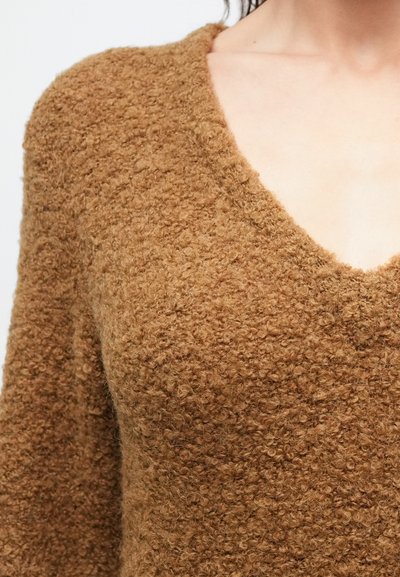 Bruine, gestructureerde trui met een diepe V-hals, gemaakt van een zacht, pluizig gebreid materiaal en lange mouwen.