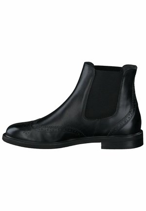 Stivale Chelsea in pelle nera con pannelli elastici laterali, dettagli brogue sulla punta e una finitura liscia. Suola piatta in gomma.