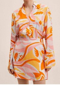 Long-sleeve dress in lightweight fabric featuring abstract patterns in pink, orange, and yellow. Buttoned front, cinched waist, and collar.