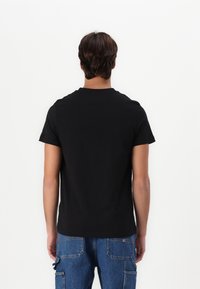 Tommy Hilfiger ARCH TEE - T-shirts med print - black