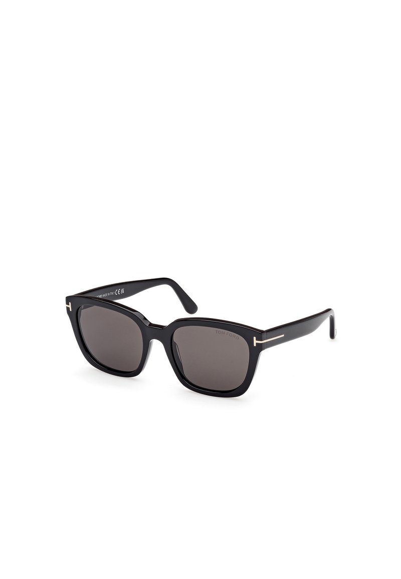 Lunettes de soleil rectangulaires noires avec des verres sombres. Fabriquées en plastique, avec des accents dorés sur la monture et une finition lisse et élégante.
