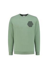 Felpa verde chiaro in cotone. Presenta un design esagonale nero sul petto. Maniche lunghe e polsini e fondo a coste.