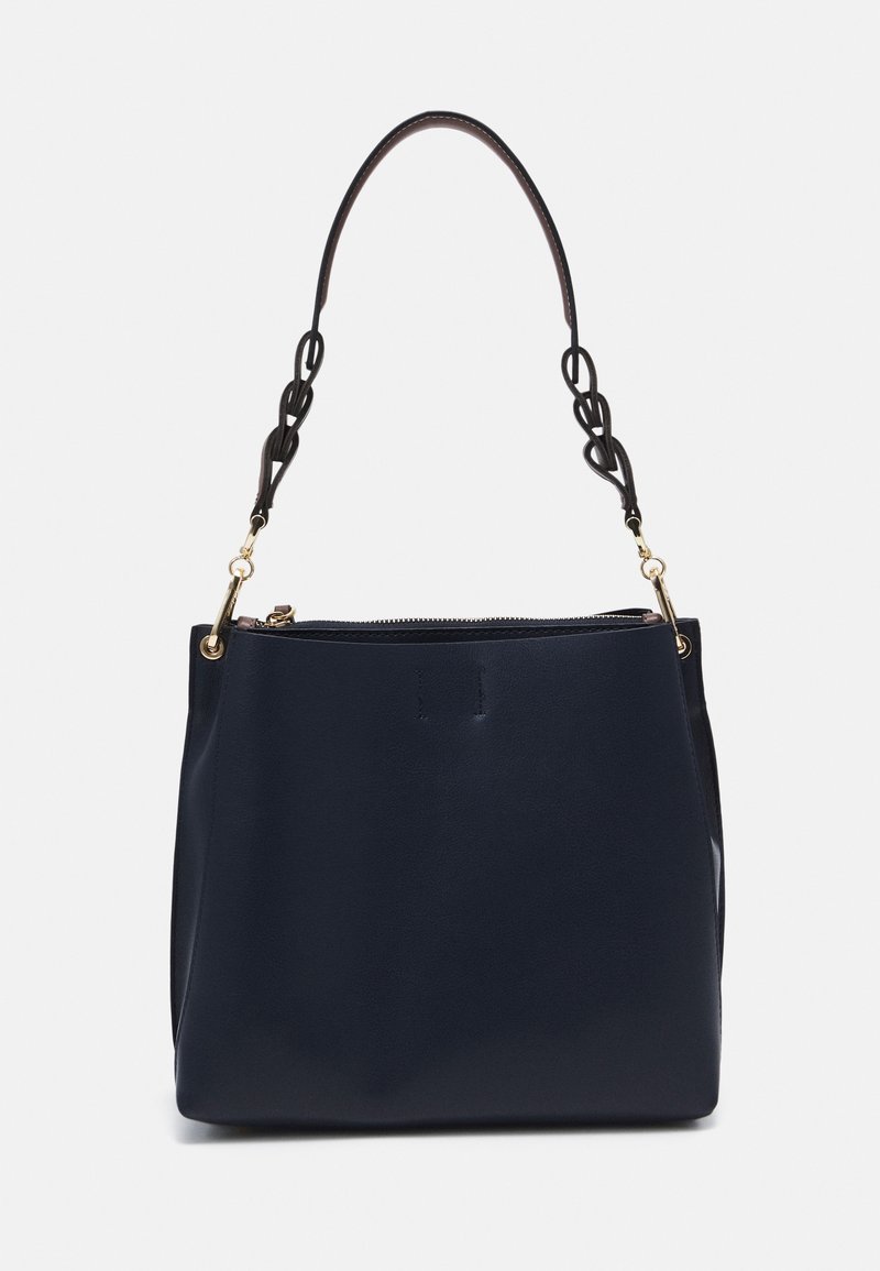 Navy blue leather handbag with a single top zipper and a twisted black leather shoulder strap attached by gold clasps.