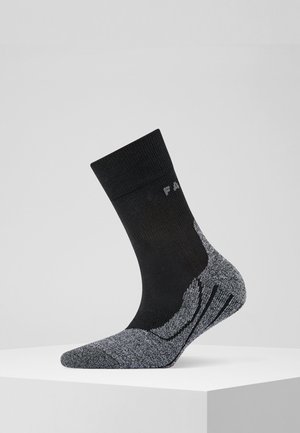 Schwarze Sportsocke mit grauem, gemustertem Fersen- und Zehenbereich, ausgestattet mit gerippter Textur und verstärkten Nähten für Langlebigkeit.