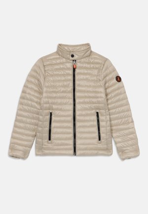 Béžová prošívaná bunda s vysokým límcem, dvěma zipovými předními kapsami, černými zipovými detaily a nášivkou s logem na levém rukávu.