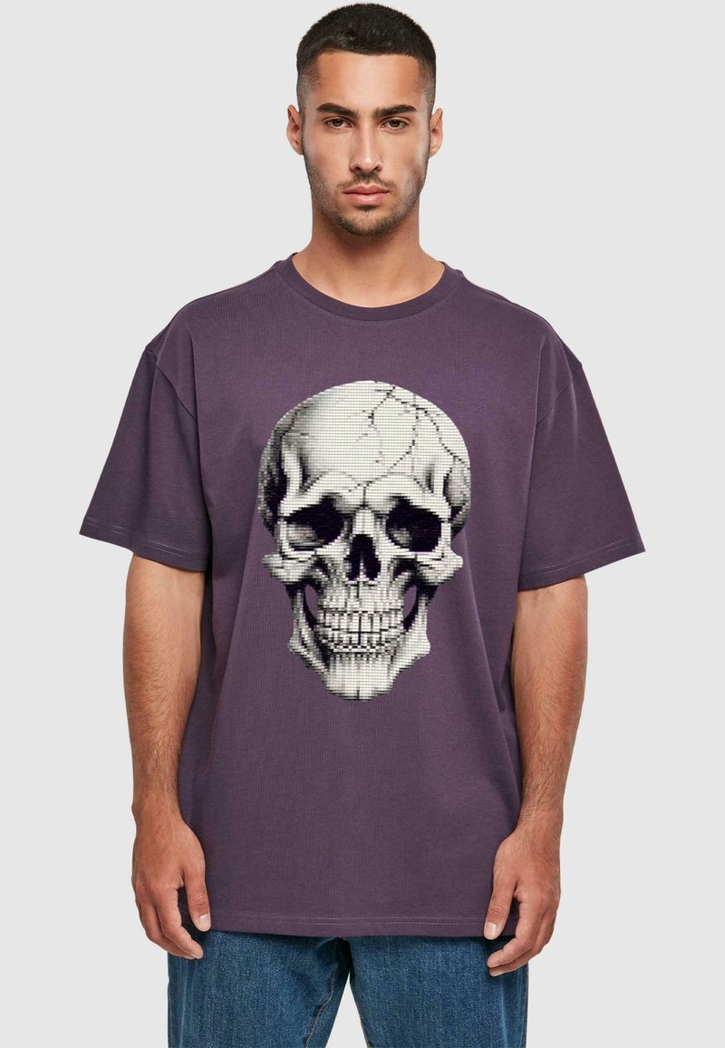 Lila bomulds T-shirt med et stort, detaljeret kraniumgrafik med revner, korte ærmer og et afslappet fit design.