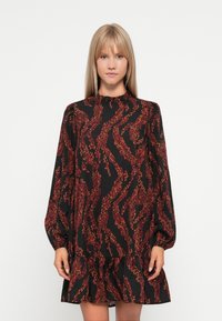 Black dress with long puff sleeves, featuring a ruffled neckline and a tiered hem. Red and orange leafy pattern throughout the fabric.